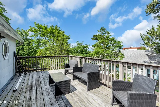 a view of balcony with wooden floor and seating space