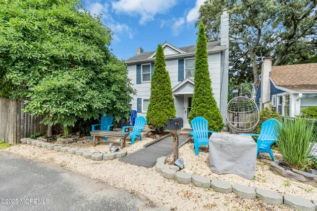 a view of a white house with a outdoor space