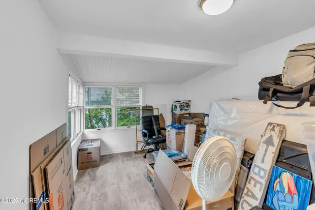 a view of living room filled with furniture and a floor to ceiling window