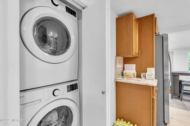 a utility room with sink dryer and washer