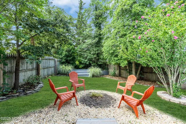 a backyard of a house with table and chairs