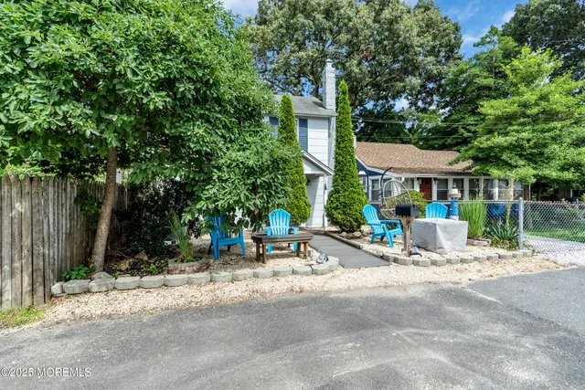 a view of a patio with a table and chairs under an umbrella