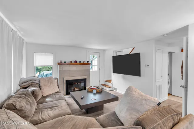 a living room with furniture a fireplace and a flat screen tv