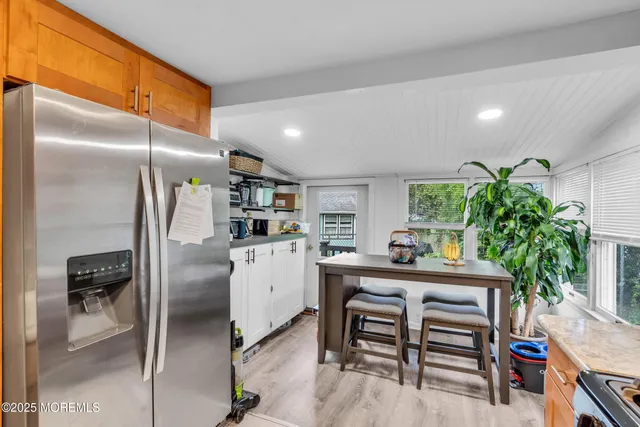 a kitchen with refrigerator and microwave