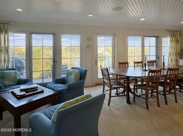 a view of a dining room with furniture and a large window