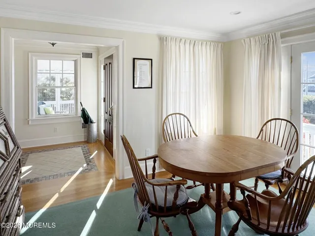 a view of a dining room with furniture and window