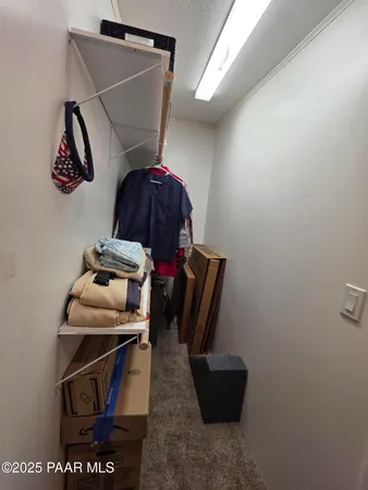 a view of dirt field with trees in background