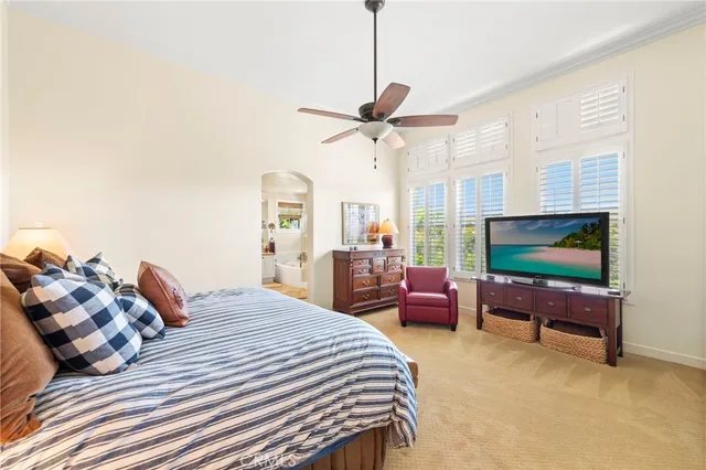 a bedroom with two beds and a chandelier