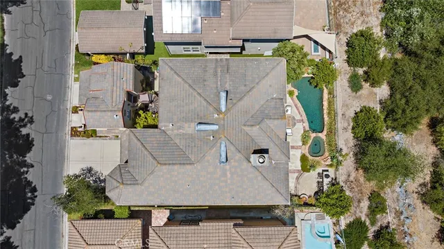 a living room with furniture a large window and a chandelier