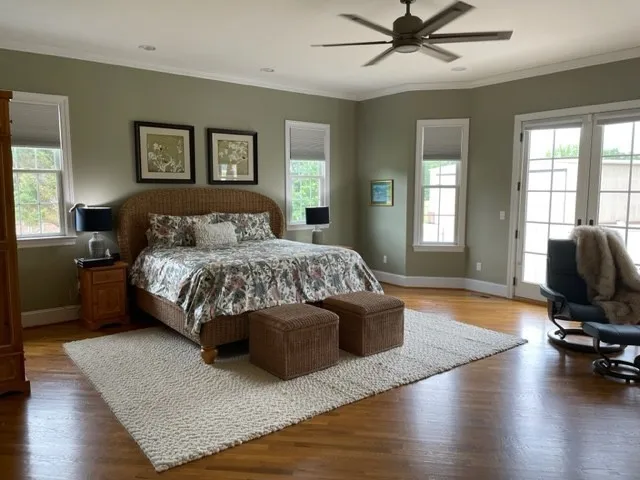 a bedroom with a bed couch and a window