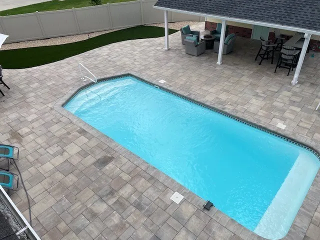 a view of a backyard with chairs