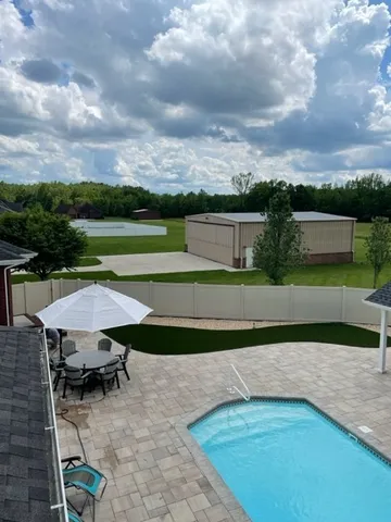 an outdoor space with furniture and city view