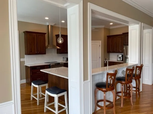 a kitchen with a dining table chairs and white cabinets