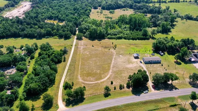 an aerial view of a house with a garden and swimming pool