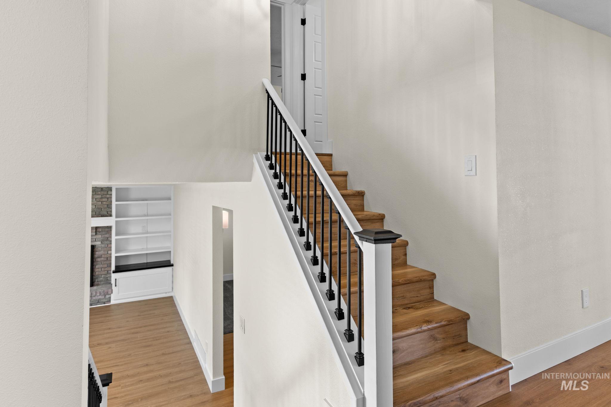 1675 Country Terrace Way Meridian, ID 83642 - Photo 14 of 50 Staircase with wood-finish treads, black metal balusters, and white risers