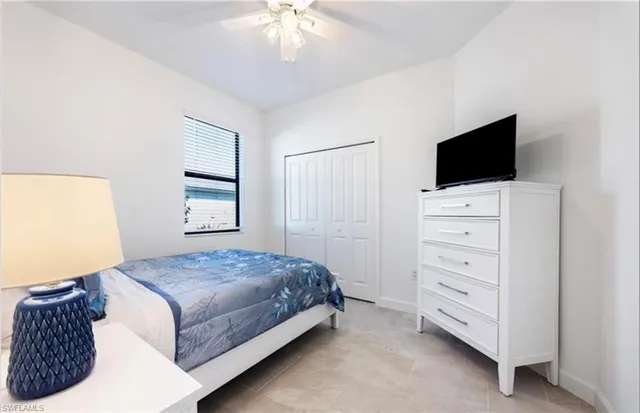 a bedroom with a bed and a television