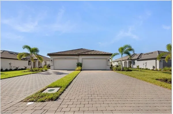 a front view of a house with a yard and garage