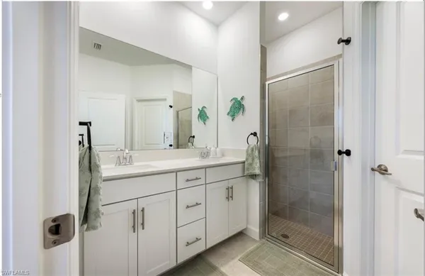 a bathroom with a glass shower door