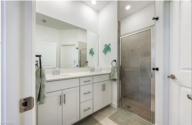 a bathroom with a glass shower door