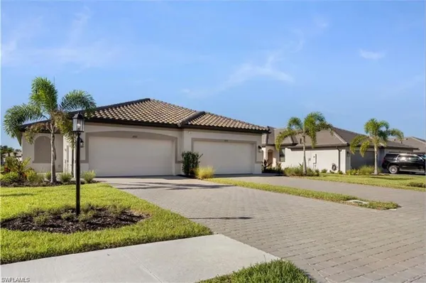 a front view of a house with a yard and garage