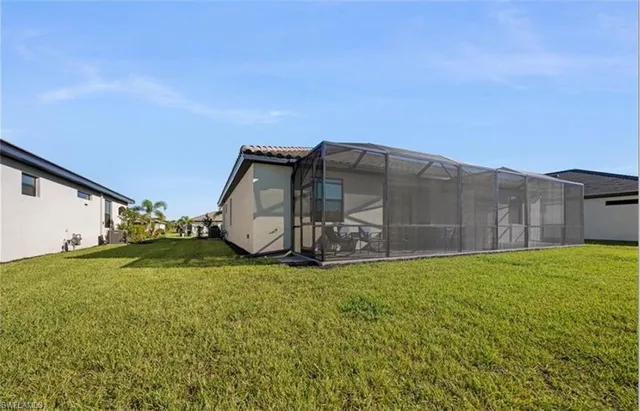 an aerial view of multiple houses with yard