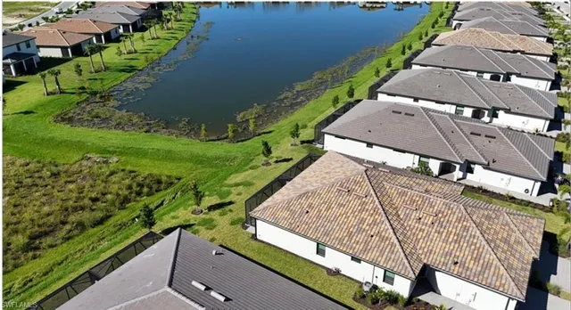 an aerial view of a house with garden space and lake view