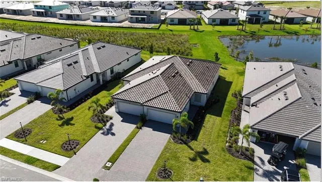 an aerial view of multiple houses with a yard
