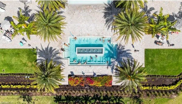 an aerial view of a residential building with outdoor space lake and trees