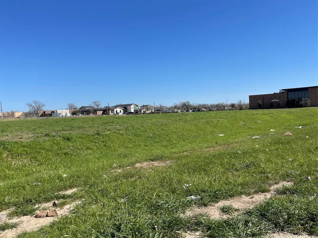 a view of a field with an ocean