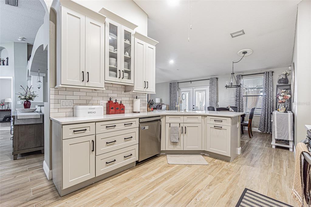 9809 La Rita Place Riverview, FL 33569 - Photo 2 of 59 a kitchen with stainless steel appliances granite countertop a stove a sink and white cabinets with wooden floor
