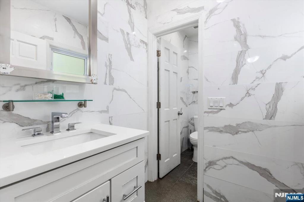 116 Westervelt Place Passaic, NJ 07055 - Photo 13 of 25 a bathroom with a sink a toilet and shower