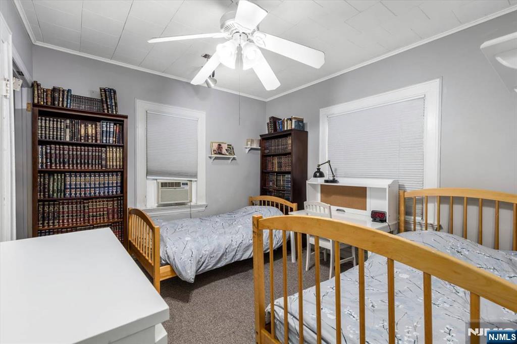 116 Westervelt Place Passaic, NJ 07055 - Photo 17 of 25 a bedroom with furniture and a window