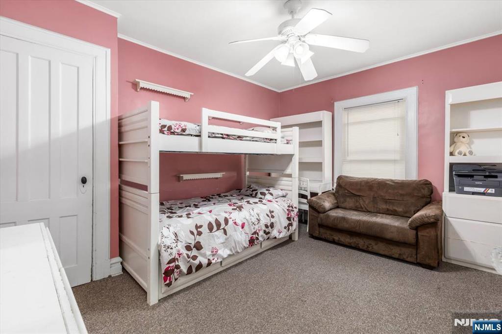 116 Westervelt Place Passaic, NJ 07055 - Photo 18 of 25 a bedroom with a bed couch and a window