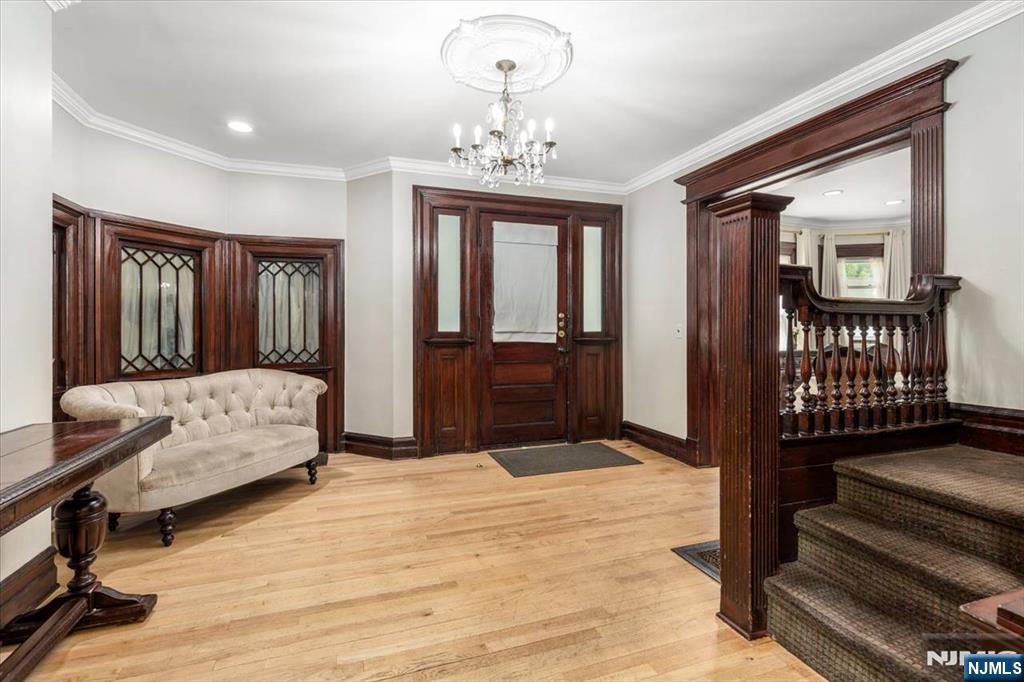 116 Westervelt Place Passaic, NJ 07055 - Photo 3 of 25 a bedroom with a bed and wooden floor