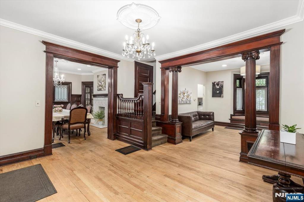 116 Westervelt Place Passaic, NJ 07055 - Photo 4 of 25 a living room with furniture and a chandelier
