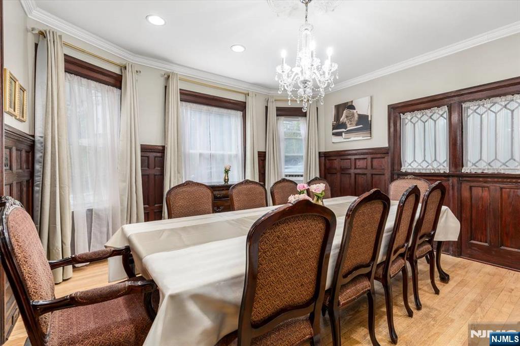 116 Westervelt Place Passaic, NJ 07055 - Photo 5 of 25 a view of a dining room with furniture and a chandelier
