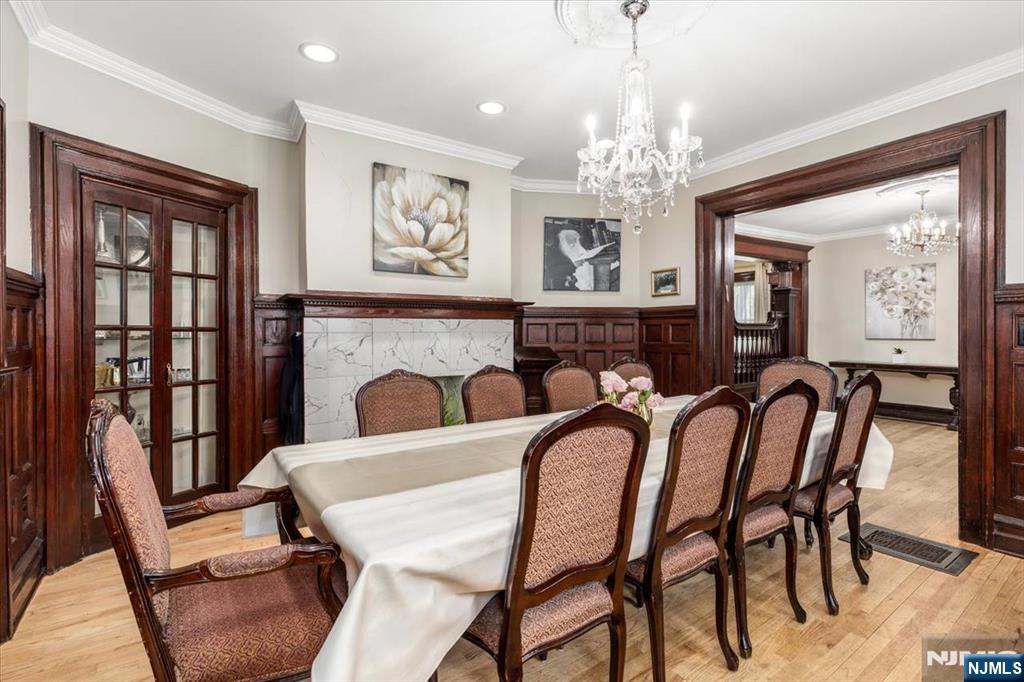 116 Westervelt Place Passaic, NJ 07055 - Photo 6 of 25 a view of a dining room with furniture a chandelier and window
