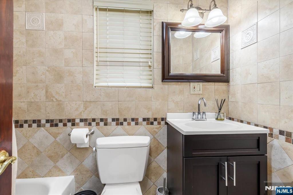 116 Westervelt Place Passaic, NJ 07055 - Photo 9 of 25 a bathroom with a sink and a mirror