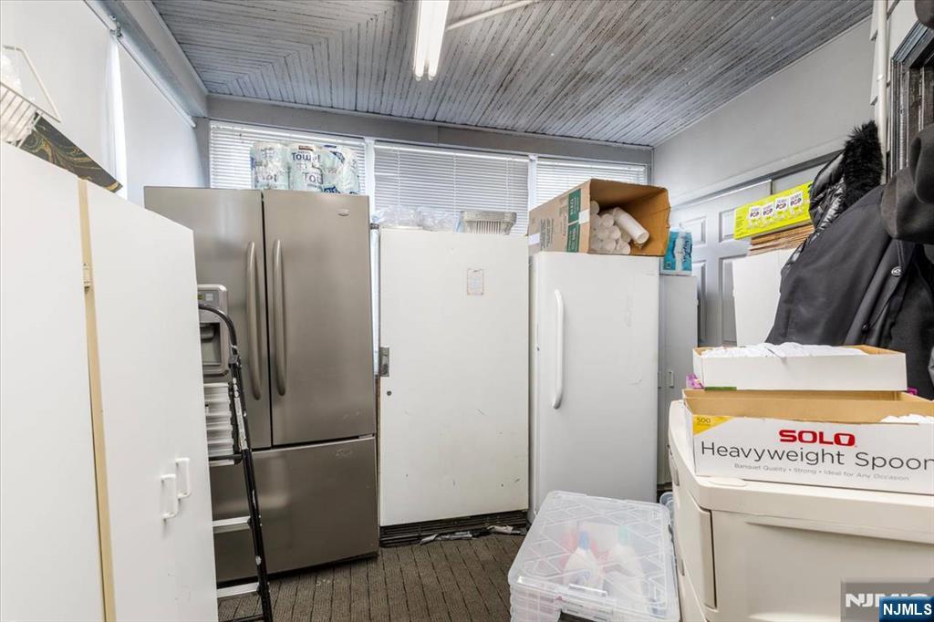 116 Westervelt Place Passaic, NJ 07055 - Photo 10 of 25 a white refrigerator freezer sitting inside of a kitchen