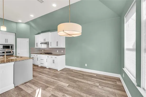 a kitchen with cabinets a sink and a stove