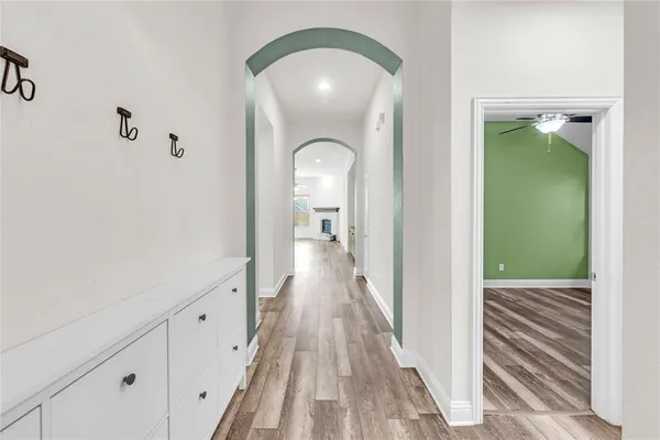 a view of a hallway view with wooden floor and staircase