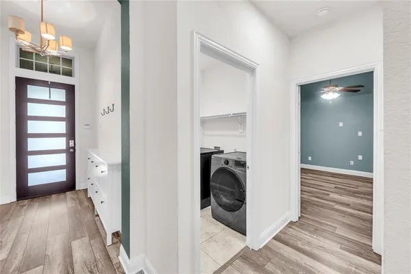 a view of a hallway with washer and dryer