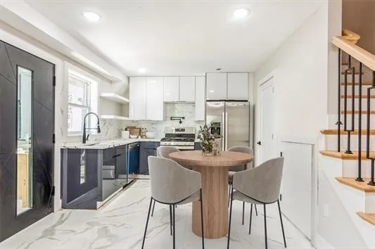 a kitchen with kitchen island a table and chairs