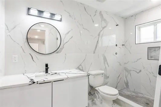 a bathroom with a sink a toilet and a mirror