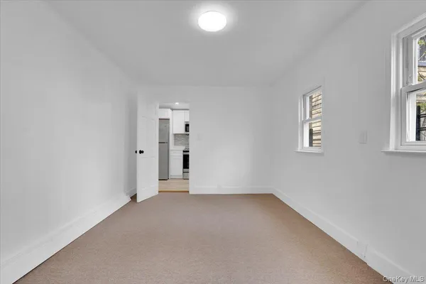 an empty room with a door and a window