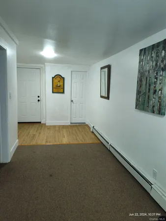 a view of a hallway with seating area