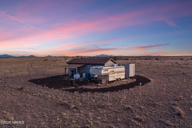 a view of a dry yard with mountain