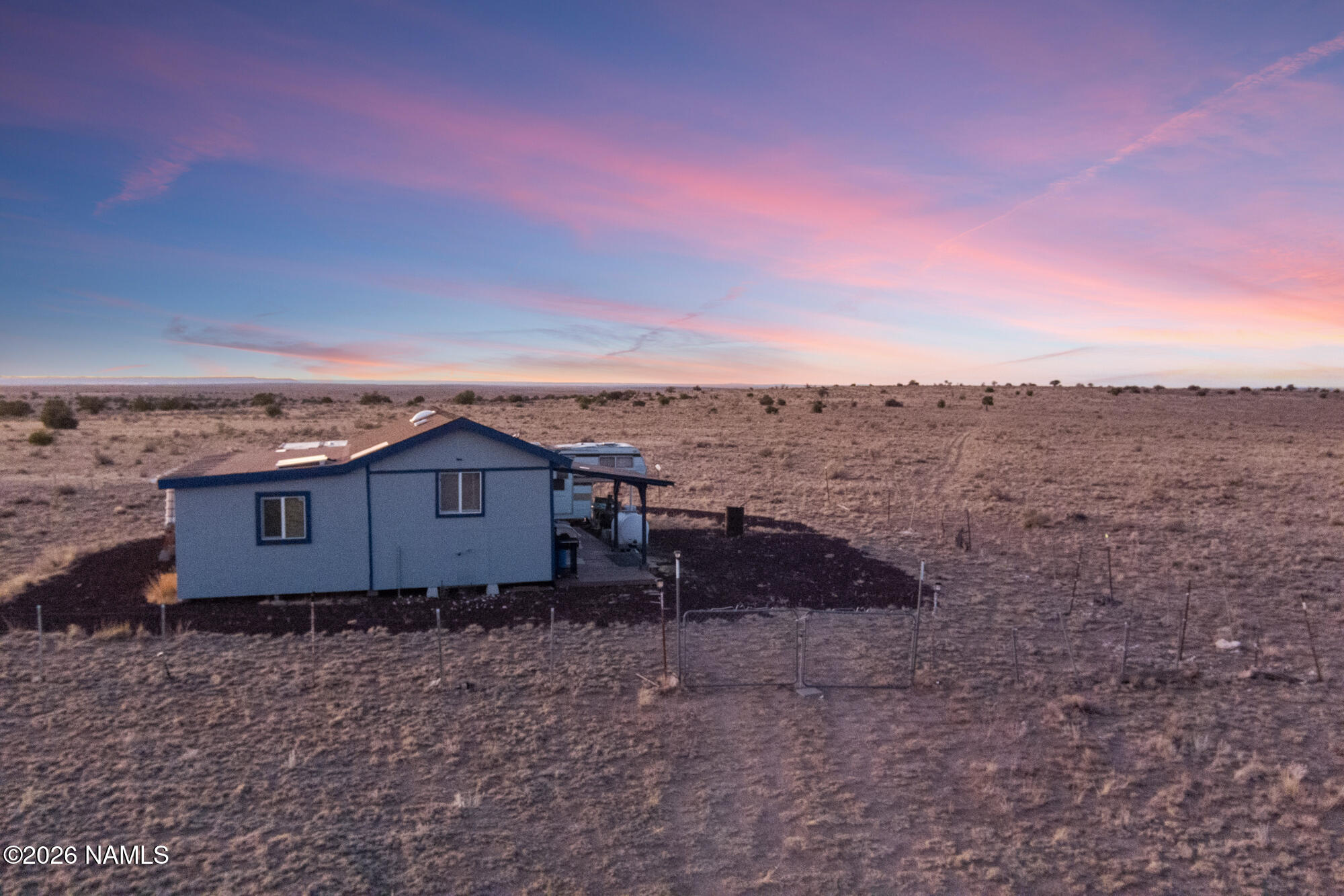 8509 West Thunder Valley Road, Unit 921 Williams, AZ 86046 - Photo 9 of 41 a view of a dry yard with wooden fence