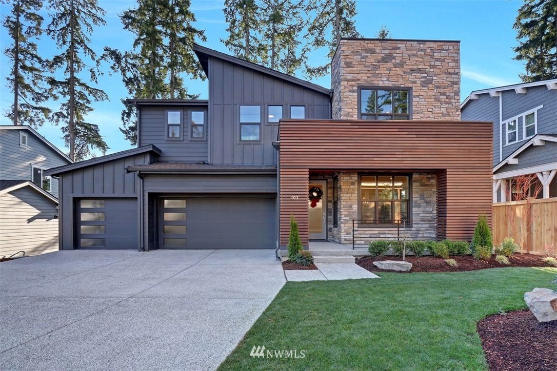 102 232nd Place Southeast, Unit 13 Bothell, WA 98021 - Photo 1 of 26 a front view of a house with a garden and yard