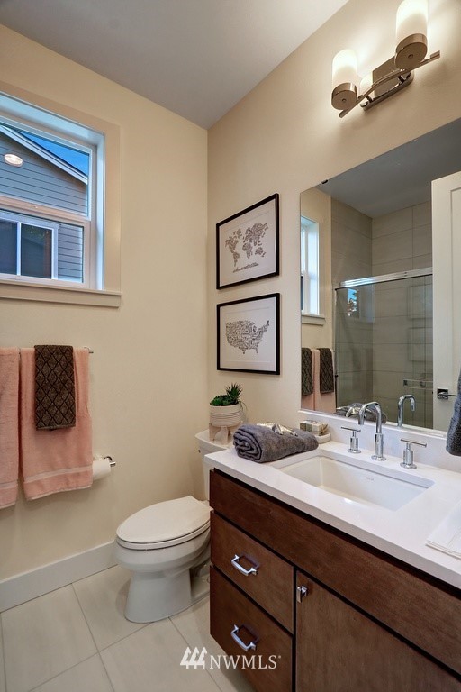 102 232nd Place Southeast, Unit 13 Bothell, WA 98021 - Photo 12 of 26 a bathroom with a toilet a sink and mirror